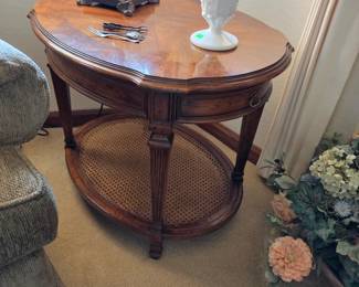 Oval wood end table with cane shelf