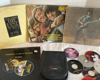 Four Vintage Albums And A CD Case With Music And Movies In It
