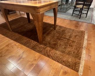 Wool brown hand knotted Rug 53 “ x 111 “ The pattern on this rug consists of concentric arcs or repeating rows of dotted textures that swirl slightly across the surface