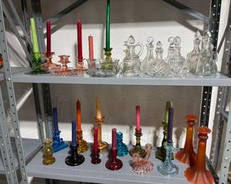 Variety of colored glass candle sticks and candles