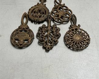 Four Wilton Miniature Cast Iron Trivets and a Wedgewood Stove Trivet