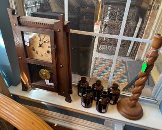 Antique Talbe Clock, Brown medicine bottles, carved candle stick
