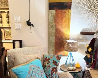 Fabric Rocking Chair, beautiful pillows, artwork and man climbing wall