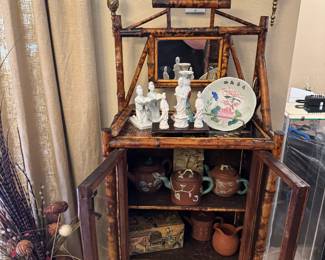 Bamboo cabinet with assorted Asian pieces
