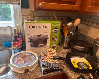 Kitchenware including new Lodge cast iron skillets and many appliances still new in boxes
