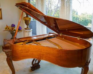 LOT 50 – Steinway Medium Grand Piano, in Walnut, 5’7”. A Steinway medium grand piano, 5 feet 7 inches, in walnut with beautifully carved acanthus legs in the French Louis XV manner, all with a “Brien lustre”. The photographs show the pristine condition of the exterior and interior, keyboard, pedals, stunning harp-shaped carving above the pedals, decorative artwork, and the factory plate marked “model M, serial 368694”. In playing condition, in tune, and has been used to perform the singing of operatic works, songs and arias in concert. Comes with matching Walnut wood, zebra piano bench.