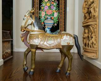 LOT 38 – Indian 20th c. Painted Toy Horse. An Indian 20th c. carved and painted wooden toy horse in full ceremonial “caparison” (an ornamental covering spread over a horse’s saddle or harness); with a peacock-form saddle, after a Maharajah’s nursery plaything. Exquisite craftsmanship & artistry. (Approx. 2.5 ft. H x 3 ft. W.); Acquired in Agra, India.