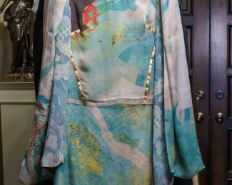 LOT 61 – Christian Lacroix, Paris - Aqua Silk Multi-Piece Evening Ensemble. A stunning Christian Lacroix silk evening ensemble in an elegant aqua, white, and multi-colored palette, accented with vibrant touches of bright red and rich brown. The camisole-style blouse features beautiful gold striping accents, while the full-length skirt continues the striking design with coordinating red and brown details. The ensemble also includes aqua silk pants and a matching aqua short silk skirt, and a coordinating silk stole in the same exquisite material, offering multiple sophisticated styling options. Sold as a full ensemble set. • Approx. Size ~8 to 8/10; Approx. Measurements: Waist: 30”, Bust: 36, Hips: 36. • Owner’s note: the gowns can be adjusted in size; there is plenty of fabric in the seams.