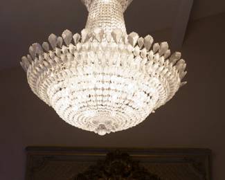LOT 23 – Contemporary Swarovski Crystal Chandelier. A Contemporary Swarovski crystal chandelier (full-size), matching the half-size Swarovski crystal chandelier in Lot 24. (Made to go together as a pair). Beautifully cut, with tiered beaded strands beneath a corona of pointed prisms. Currently crated.