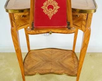 LOT 09 – French, 18th c. Louis XV Reading Table. A French 18th c. marquetry reading table with an adjustable reading shelf, drawers, and a lower tier; with beautifully-patterned inlays and gilt metal mounts.