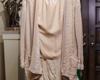 LOT 60 – Elegant Donna Karan Cream Silk & Beaded Evening Ensemble, with Extra Separates. A sophisticated Donna Karan cream ensemble featuring versatile evening separates, including cream silk-brocade pants and a cream silk blouse with a delicate, subtle circular pattern. The ensemble is beautifully complemented by a matching heavily beaded sweater, adorned with lustrous pearl beads and exquisite hand-sewn detailing along the back, sleeve hems, and throughout the front opening. Two elegantly accented front pockets complete the sweater’s beautifully designed and richly embellished look. Sold as a full ensemble set. • Approx. Size ~8 to 8/10; Approx. Measurements: Waist: 30”, Bust: 36, Hips: 36. • Owner’s note: the gowns can be adjusted in size; there is plenty of fabric in the seams.