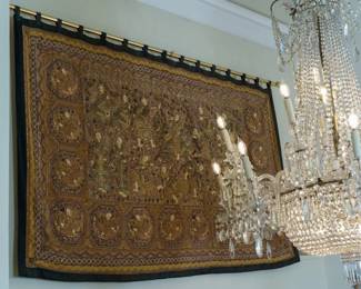 LOT 08 – South East Asian 19th c. Wall Hanging, Beaded Tapestry. 19th c. Burmese large horizontal embroidered and appliqué textile wall hanging, with tapestry weaving using metallic thread, sequins, beads and decorative cabochons. An exquisite tapestry that was made with a special technique of sewing (known as the “Kalaga” tradition). This technique embellishes the piece with sequins, stones, metallic and beautifully colored threads of all shades. This piece has a gold-and-brown figurative composition: figures are in a scene showing priests, a royal family, men courting on horseback, and 14 separate circle enclosures with spiritual dancers, all with bordered panels and a dark outer edge. Purchased in Palo Alto in 1983, and described by the owner as originating from a Burmese spiritual temple.