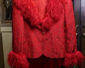 LOT 62 – Dramatic Bright-Red Brocade & Mouton Lamb Statement Ensemble. A breathtaking bright-red silk crepe brocade jacket trimmed in luxurious Mouton lamb, featuring a dramatic large portrait collar and matching red lamb cuffs. A true statement piece, the jacket can be styled over several coordinating camisoles, including a red silk, sequined-underlay and lace camisole and a beautiful brocade silk and lace camisole. The ensemble also includes a matching red silk long skirt and an elegant silk chiffon scarf, which can be draped or thrown over the ensemble as a graceful cape. Designed by famous fashion and costume designer Margi Kent. Sold as a full ensemble set. • Approx. Size ~8 to 8/10; Approx. Measurements: Waist: 30”, Bust: 36, Hips: 36. • Owner’s note: the gowns can be adjusted in size; there is plenty of fabric in the seams.
