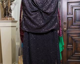LOT 58 – Striking Black Sequined Evening Ensemble & Statement Jacket. A glamorous black sequined sheer chiffon blouse, beautifully ruched around the bust and finished with elegant cap sleeves, pairs with a full-length sheer chiffon skirt lavishly embellished with beads and sequins throughout. The ensemble also includes a full-length black crepe skirt, offering a sophisticated alternate look. The accompanying jacket is a stand-alone statement piece, crafted from strikingly small and flat sequined material in an eye-catching black-and-white snake and leopard pattern. Designed by famous fashion and costume designer Margi Kent. Sold as a full ensemble set. • Approx. Size ~8 to 8/10; Approx. Measurements: Waist: 30”, Bust: 36, Hips: 36. • Owner’s note: the gowns can be adjusted in size; there is plenty of fabric in the seams.