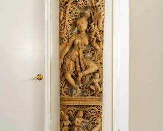 LOT 35 – Indian 20th c. Dancing Apsara Teak Wall Panel. A tall, beautifully carved Teak wood wall panel, depicting a dancing Apsara within a densely pierced foliate surround; above a lower register of figures and animals; below beautifully carved native exotic parrots and other whimsical animals. (~6 Ft. H x ~2 Ft. W.) Acquired in Agra, India.