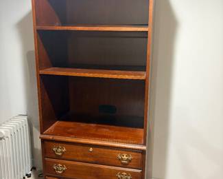 Cherry finish bookcase with open shelves and two lower drawers