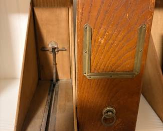 Vintage oak magazine or file holder with brass trim and ring pull