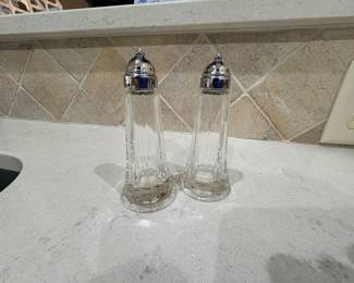 Tall glass salt and pepper shakers with silver tone tops