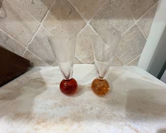 Pair of art glass champagne flutes with red and amber bubble bases