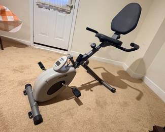 Folding recumbent exercise bike with backrest and digital monitor