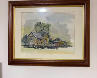 Framed watercolor print of country farmhouse in wood frame with gold liner