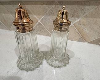 Pressed glass salt and pepper shakers with gold tone tops