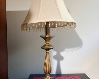 Brass candlestick table lamp with beaded fringe shade