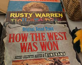 Vintage vinyl LP records including How the West Was Won soundtrack and Rusty Warren
