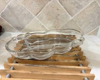 Clear glass divided relish dish on wood slat trivet
