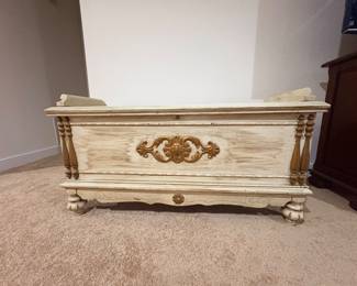 Vintage cedar chest with carved scroll accent and turned legs