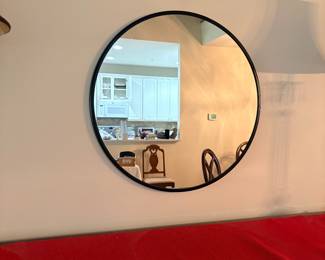 Round black framed wall mirror