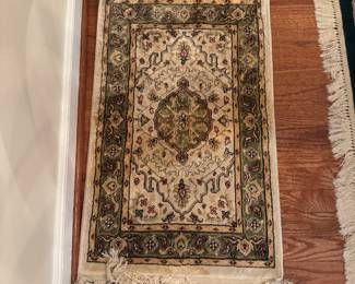 Oriental style area rug with cream and gold medallion