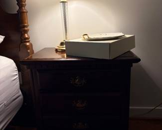 Cherry three drawer nightstand with brass and glass table lamp