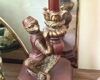 Vintage resin candlestick holder featuring a monkey figure wearing a vest and fez, styled with gilded accents on a stepped pedestal base.