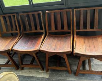 Vintage to antique wooden chairs made out of wagon wheels