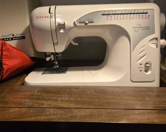 Singer sewing machine in vintage cabinet