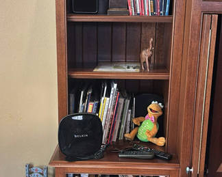 Lot 113: Books, Elephant Figurines, and Speaker on Wooden Bookshelf
