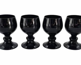 Four black goblets on pure white