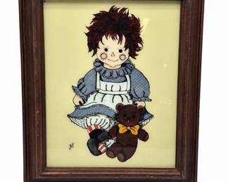 Raggedy Ann in a worn wooden frame