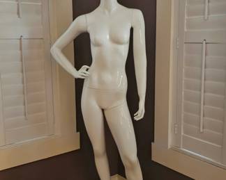 Full-body, gloss white female egghead mannequin.