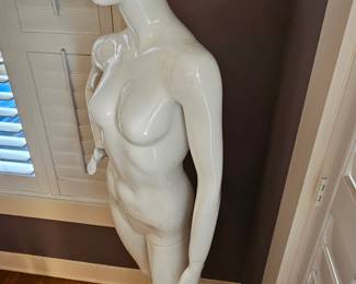 Full-body, gloss white female egghead mannequin.