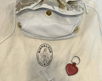 Lot 345: Carlos Falchi White and Gold Handbag with Red Heart Keychain