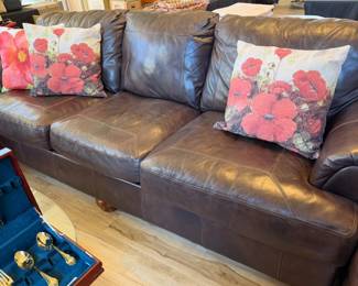 Leather sofa and poppy decor throw pillows
