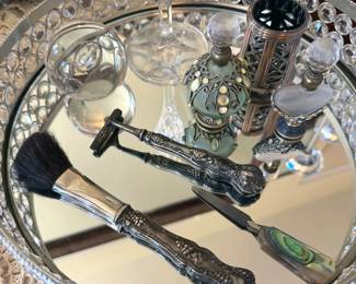 Perfume bottles, mirrored tray, makeup brush