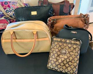 Assorted fashion purses: labeled YSL, Coach, Dooney + Bourke, Michael Kors,Antonio Melani