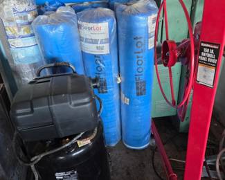 compresser and rolls on insolation and sheet rock stand