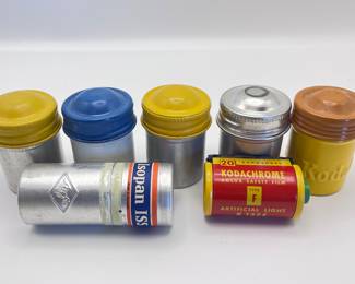 Vintage film canisters (along with a vintage roll of film)
