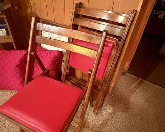 Vintage wooden folding chairs with red vinyl seats 
