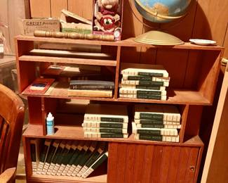 Vintage enclypedias, globe, other finds on a fun bookshelf.