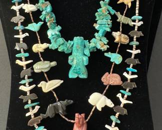 A collection of finely carved Native American fetish necklaces. Zuni multi gem, one with protective animals signed under central standing bear. A stacked old matrix turquoise necklace. Not shown, a Purple Spiny Oyster triple strand. 